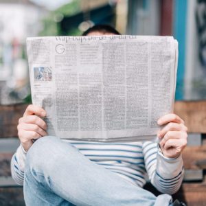 A man holding a newspaper.